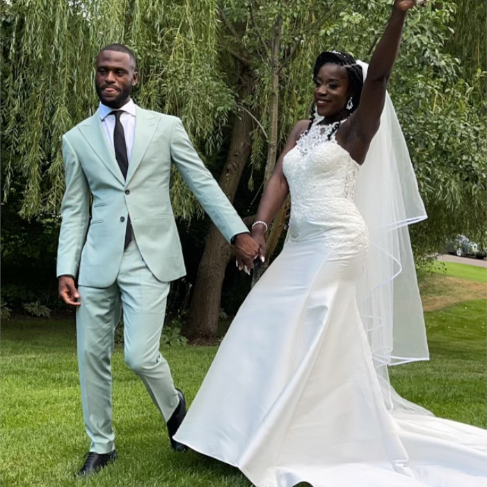 wedding photo of a couple walking hand in hand