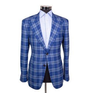 A sky blue plaid sport jacket on a body form with a very light blue shirt on a white background