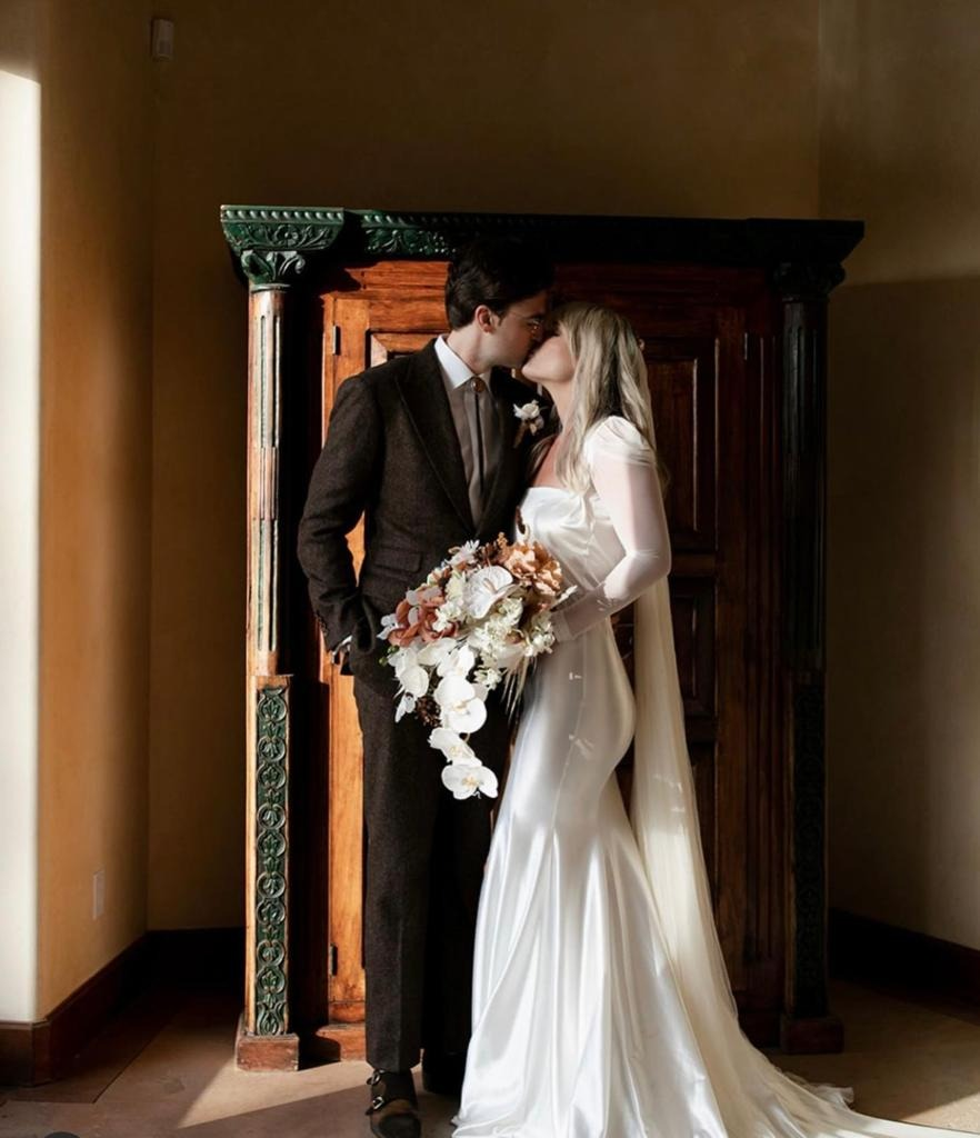 A man wearing a brown suit for a fall wedding