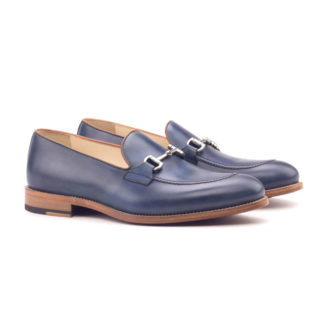 The Richmond: Navy Calf. Navy box calf leather loafers with metal buckles against white background.