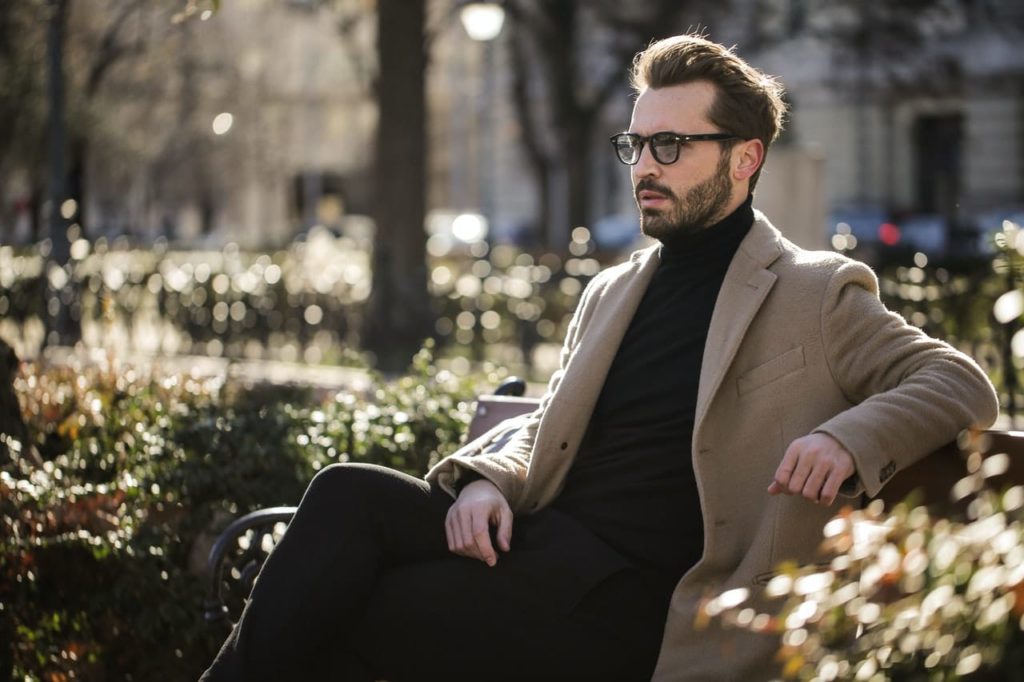 man-sitting-on-black-metal-bench-under-the-sun-3760274