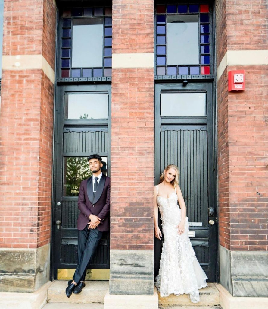 Wedding portrait. The groom is wearing a custom purple colored tuxedo jacket